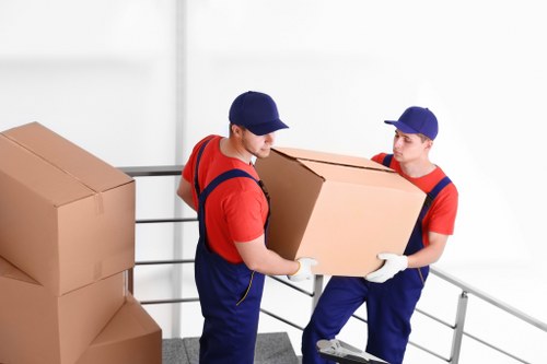 Movers carrying furniture in a Lewisham apartment building