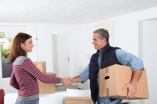 Loading household furniture into a moving truck in Lewisham